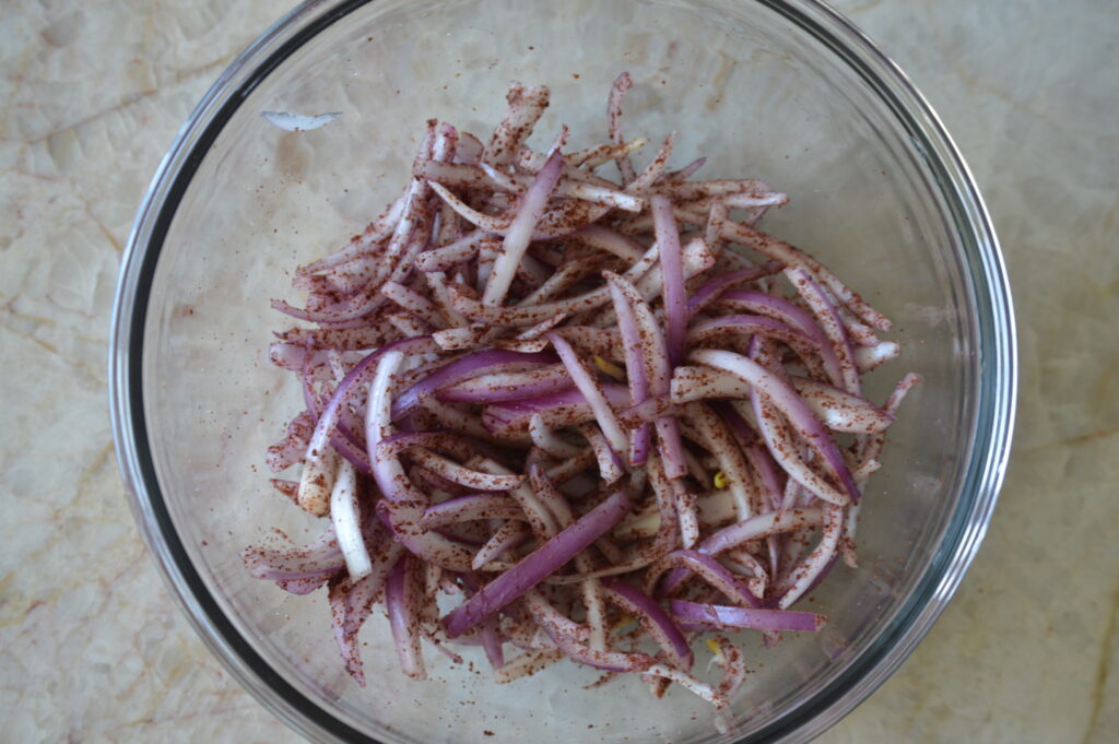 the onions are massaged with salt and sumac
