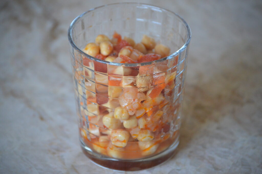 some of the chickpeas are added to a cup