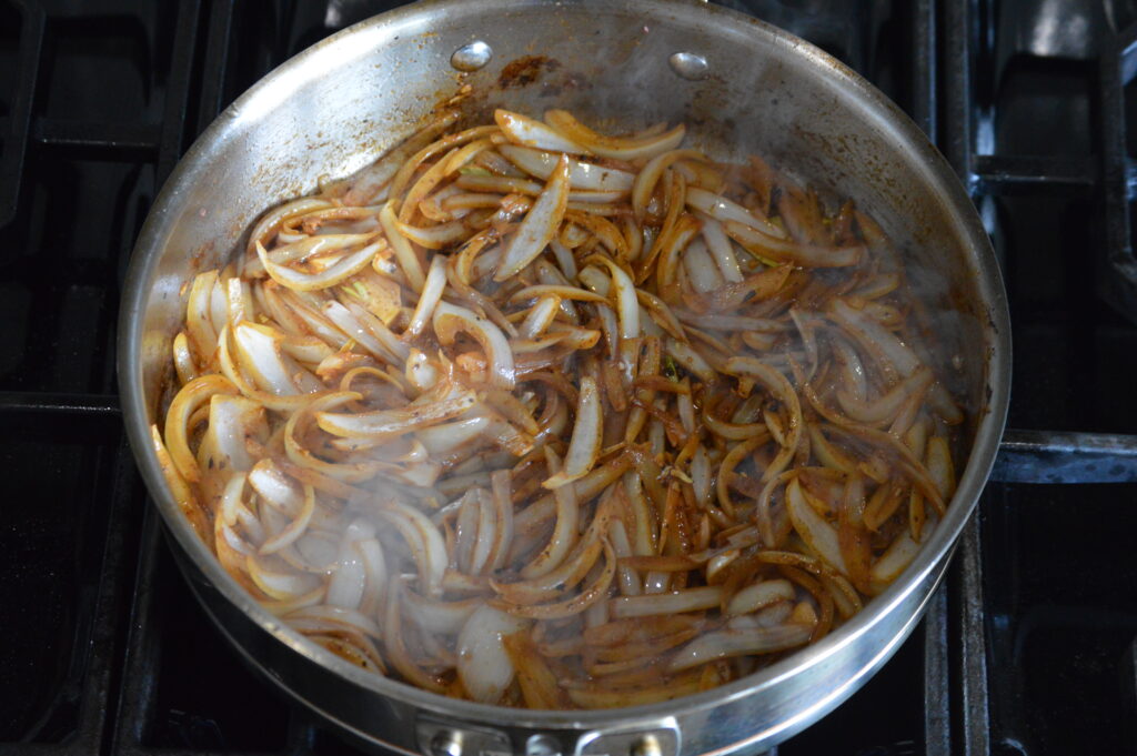 cooking the onions in the pan until caramelized