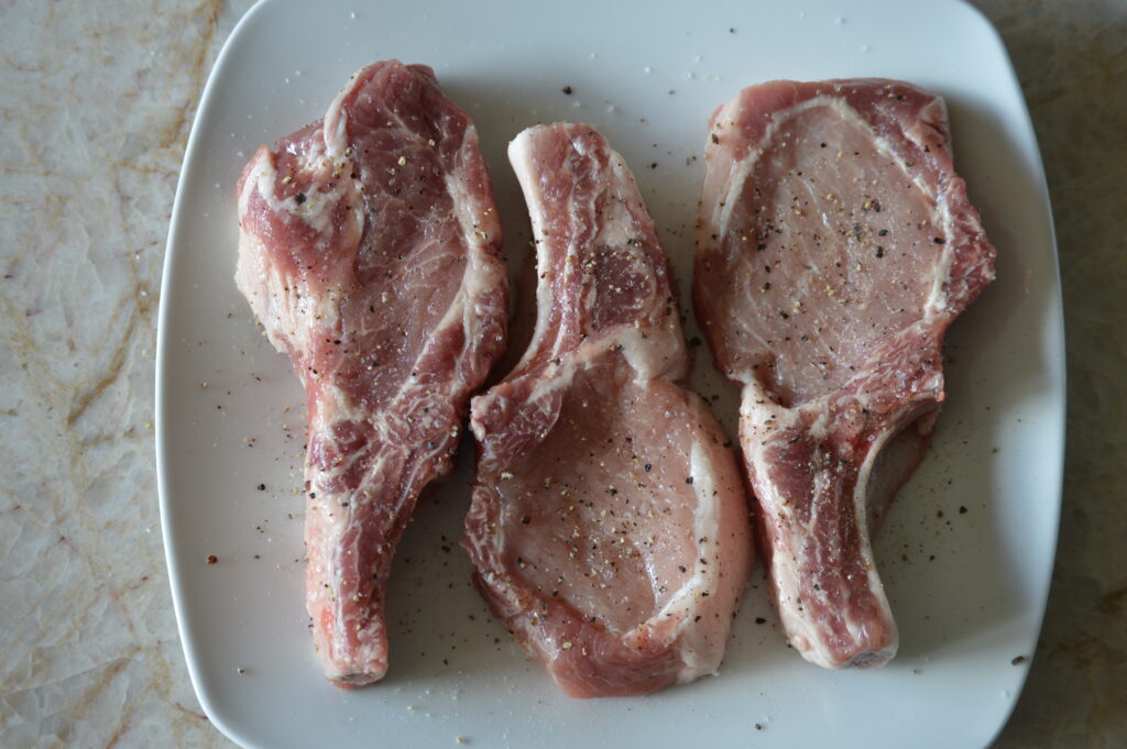 the chops are sprinkled with salt and pepper
